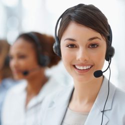 Closeup of a cute business woman with headset at workplace